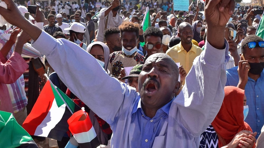 Sudan protesters march on the presidential palace to demand that the military leave politics