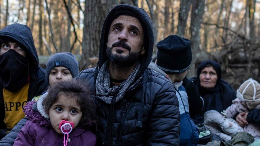 -- AFP PICTURES OF THE YEAR 2021 --

Members of a Kurdish family from Dohuk in Iraq are seen in a forest near the Polish-Belarus border while waiting for the border guard patrol, near Narewka, Poland, on November 9, 2021.  - The three-generation family of 16 members with seven minors, including the youngest who is 5 months old, spent about 20 days in the forest and was pushed back to Belarus 8 times.  They claim they were beaten and frightened with dogs by Belarusian soldiers.  (Photo by Wojtek RADWANSKI  /  AFP)  /  AFP PICTURES OF THE YEAR 2021
