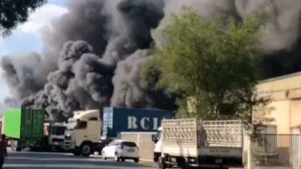 Thick plumes of smoke billow from two warehouses in Dubai