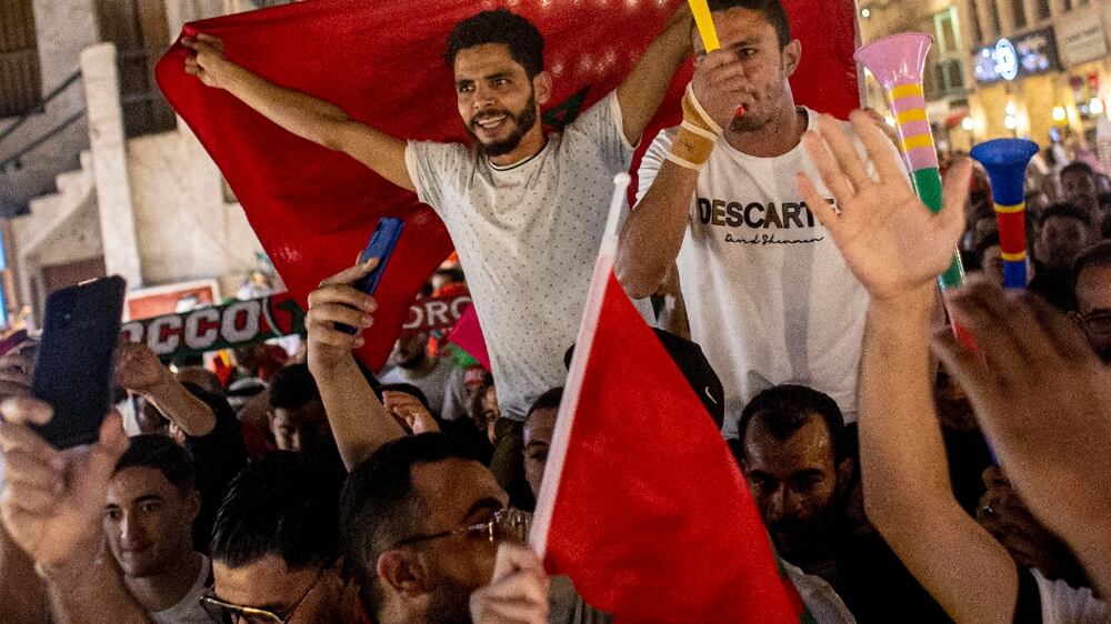 Fans of Morocco celebrate after Morocco won the FIFA World Cup 2022 Round of 16 match against Spain, at the Souq Waqif market in Doha, Qatar, 06 December 2022.   EPA / MARTIN DIVISEK