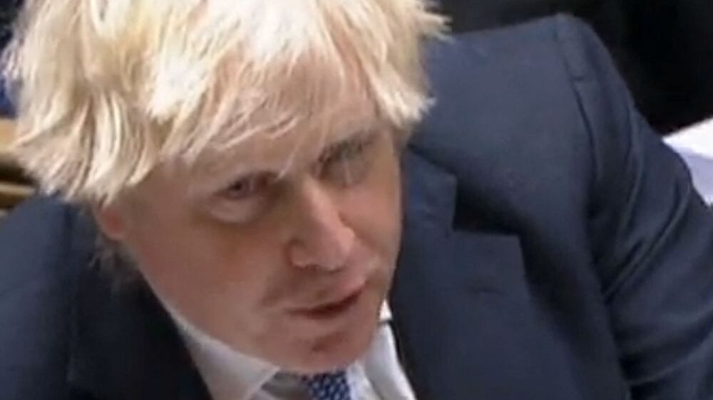 A video grab from footage broadcast by the UK Parliament's Parliamentary Recording Unit (PRU) shows British Prime Minister Boris Johnson speaking during Prime Minister's Questions (PMQs), in the House of Commons in London on December 8, 2021.  - British Prime Minister Boris Johnson faced intense pressure Wednesday after a video emerged of his senior aides joking about holding a Christmas party at Downing Street last year when social gatherings were banned under Covid-19 rules.  (Photo by PRU  /  AFP)  /  RESTRICTED TO EDITORIAL USE - NO USE FOR ENTERTAINMENT, SATIRICAL, ADVERTISING PURPOSES - MANDATORY CREDIT " AFP PHOTO  /  PRU "