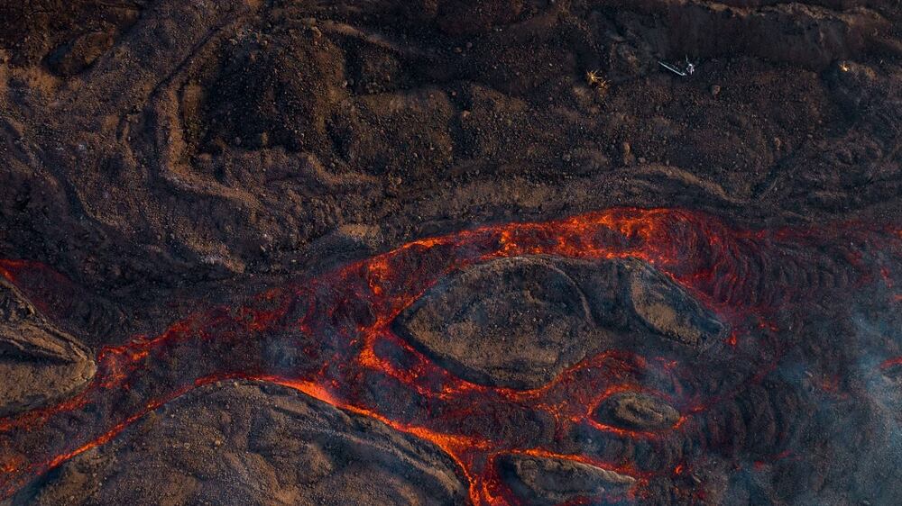 Lava flows destroying houses during an eruption in Las Manchas village, on the Canary island of La Palma, Spain, Monday, Dec.  6 2021.  (AP Photo / Emilio Morenatti)