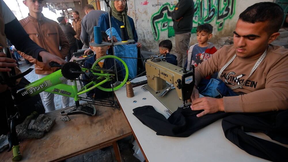 Tailor from Gaza rigs bicycle to help power his sewing machine
