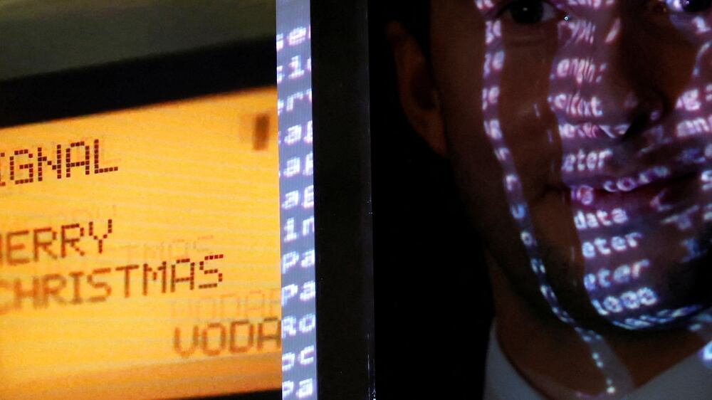 Aguttes auction house head of development Maximilien Aguttes holds a non-fungible token (NFT), replica of the original communication protocol that transmitted the first SMS text message ever sent, before its auction by Britain's Vodafone, in Neuilly-sur-Seine, near Paris, France, December 20, 2021.   REUTERS / Christian Hartmann