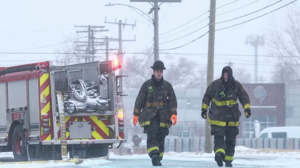 DETROIT, MI - DECEMBER 23: Firefighters with the Detroit Fire Department try to remove ice from their fire hoses while fighting a warehouse fire on December 23, 2022 in Detroit, United States.  A major winter storm swept over much of the midwest on Friday, dropping temperatures to single digits and windchills up to -35 degrees Fahrenheit.    Matthew Hatcher / Getty Images / AFP (Photo by Matthew Hatcher  /  GETTY IMAGES NORTH AMERICA  /  Getty Images via AFP)