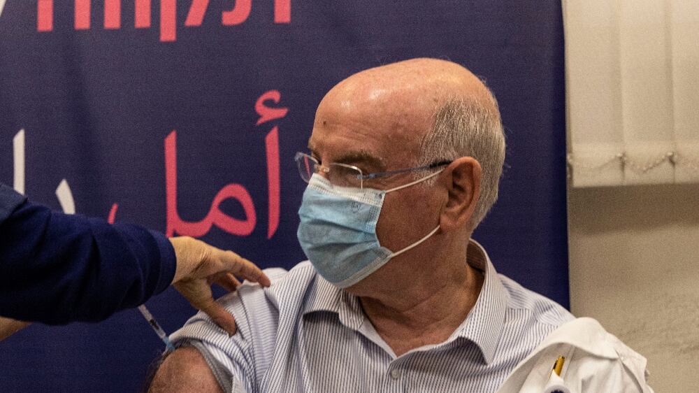 Professor Jacov Lavee receives a fourth dose of Pfizer-BioNTech COVID-19 vaccine, at Sheba Medical Center in Ramat Gan, Israel, Monday, Dec.  27, 2021.  Israel began trials of a fourth dose of coronavirus vaccine on Monday with 150 medical personnel who received a booster dose in August in what is believed to be the first study of its kind.  (AP Photo / Tsafrir Abayov)