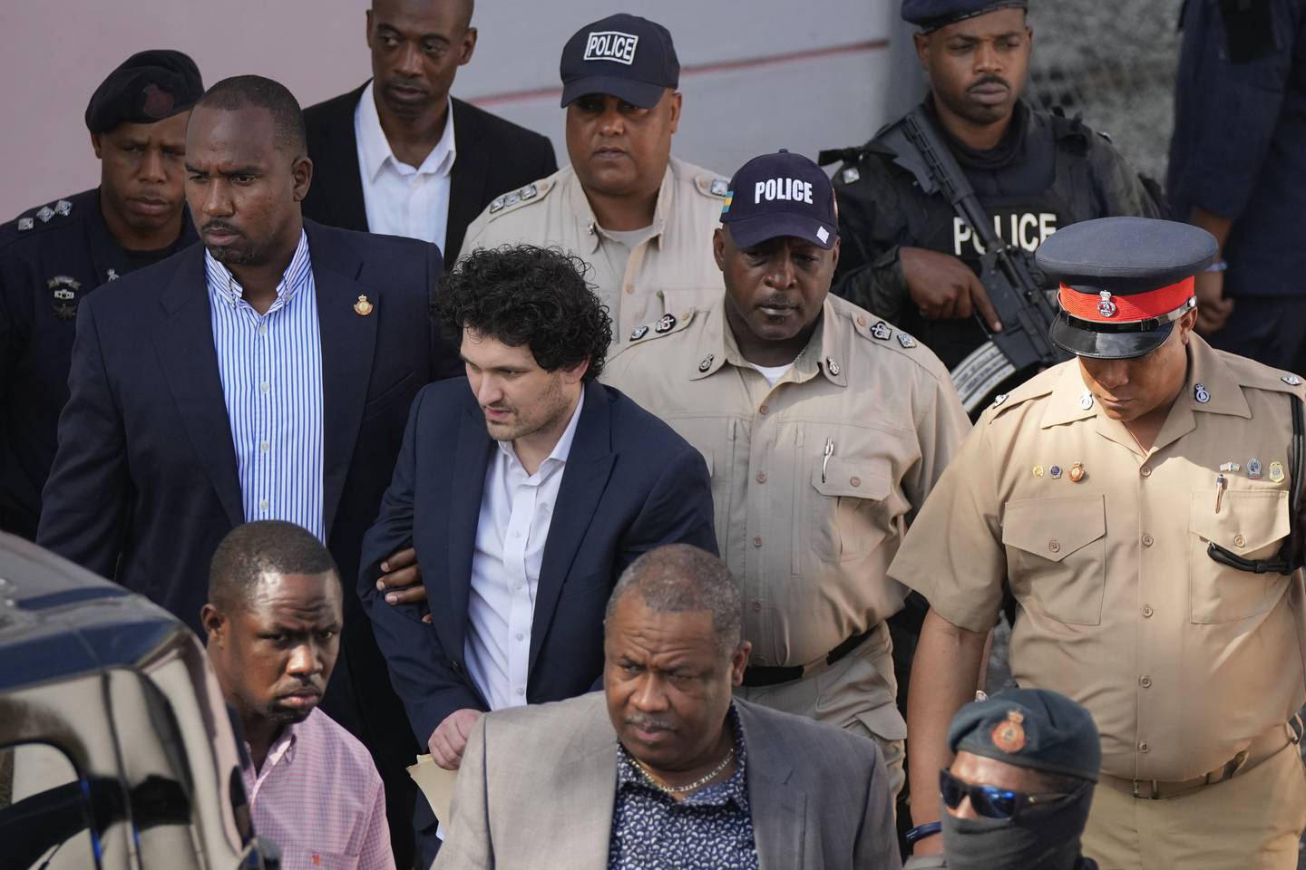 Sam Bankman-Fried, co-founder of the failed cryptocurrency exchange FTX, is escorted out of Magistrate Court after a hearing in Nassau, Bahamas, last month. AP