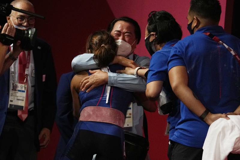 Hidilyn Diaz of Philippines celebrates with Weightlifting Philippines federation president Monico Puntuevella after winning the gold medal.