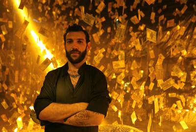 Lebanese artist Carlo Kassabian poses with his art installation titled 'Menhara' (collapsed) reflecting on the devaluation of the Lebanese pound, at a club in Beirut. AFP