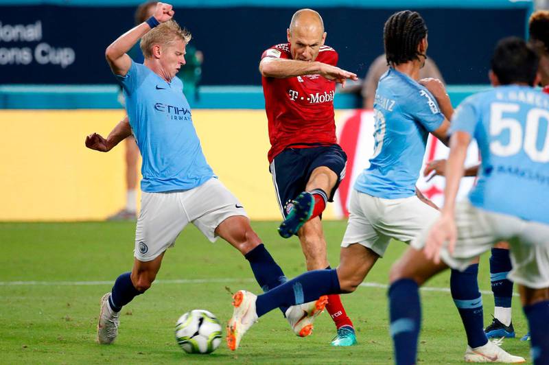 Bayern Munich's Arjen Robben shoots the ball past Manchester City's Oleksandr Zinchenko. AFP