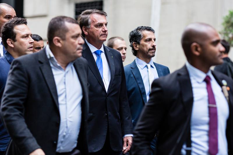Brazil's President Jair Bolsonaro, centre, walks outside his hotel while in New York for the UN General Assembly. Reuters