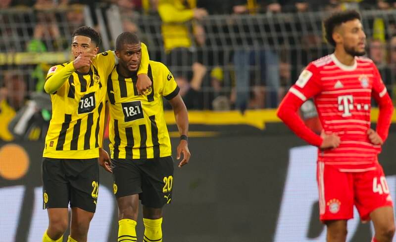 Anthony Modeste celebrates with Jude Bellingham after scoring Borussia Dortmund's second goal against Bayern Munich. EPA