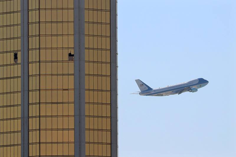 Air Force One departs Las Vegas past the broken windows on the Mandalay Bay hotel, where shooter Stephen Paddock conducted his mass shooting along the Las Vegas Strip in Las Vegas, Nevada, U.S., October 4, 2017.       REUTERS/Mike Blake     TPX IMAGES OF THE DAY