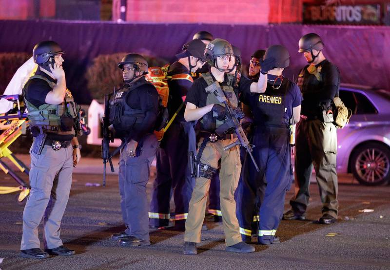 Police officers stand at the scene of a shooting near the Mandalay Bay resort and casino on the Las Vegas Strip. John Locher / AP Photo