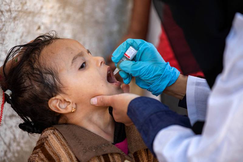 Another Yemeni child receives a polio vaccination during a home visit by health workers.