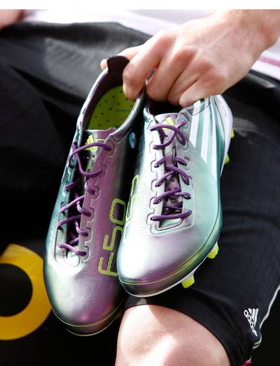 Argentina's national soccer team player Lionel Messi displays the new F50 adiZero soccer boots during a promotional event at Montmelo circuit near Barcelona May 11, 2010. The boots, weighing only 165 grams, are the lightest in the world and they will be featured in the upcoming World Cup in South Africa, according to Adidas.   REUTERS/Gustau Nacarino  (SPAIN - Tags: SPORT SOCCER WORLD CUP BUSINESS)