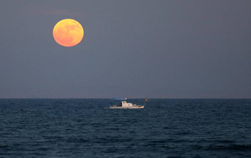 A fishing boat sails as so-called 'Supermoon' rises in Larnaca, Cyprus. Katia Christodoulou / EPA