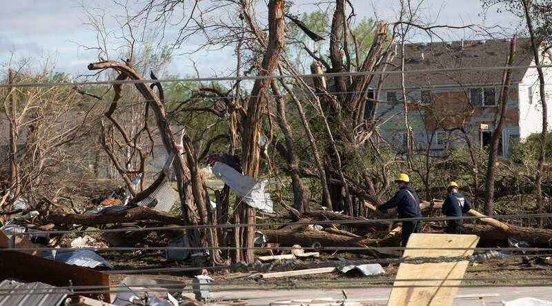 Wichita firefighters search what's left of John's Animal World in Andover, Kansas, after the tornado. AP
