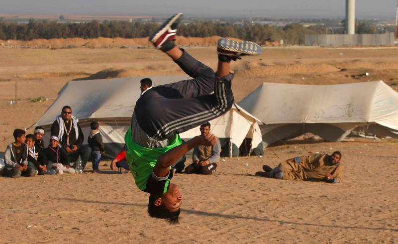 A Palestinian youth practices his parkour skills at the Israel-Gaza border in the southern Gaza Strip. Mohammed Salem / Reuters