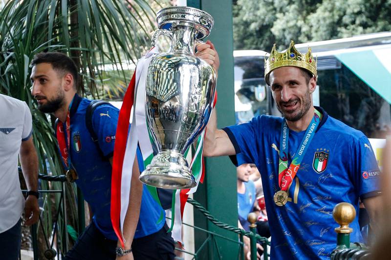 Italy captain Giorgio Chiellini with the Euro 2020 trophy next to goalkeeper Gianluigi Donnarumma after the team arrived at the Parco dei Principi hotel in Rome on Monday, July 12. Italy won the Euro 2020 final against England on Sunday.