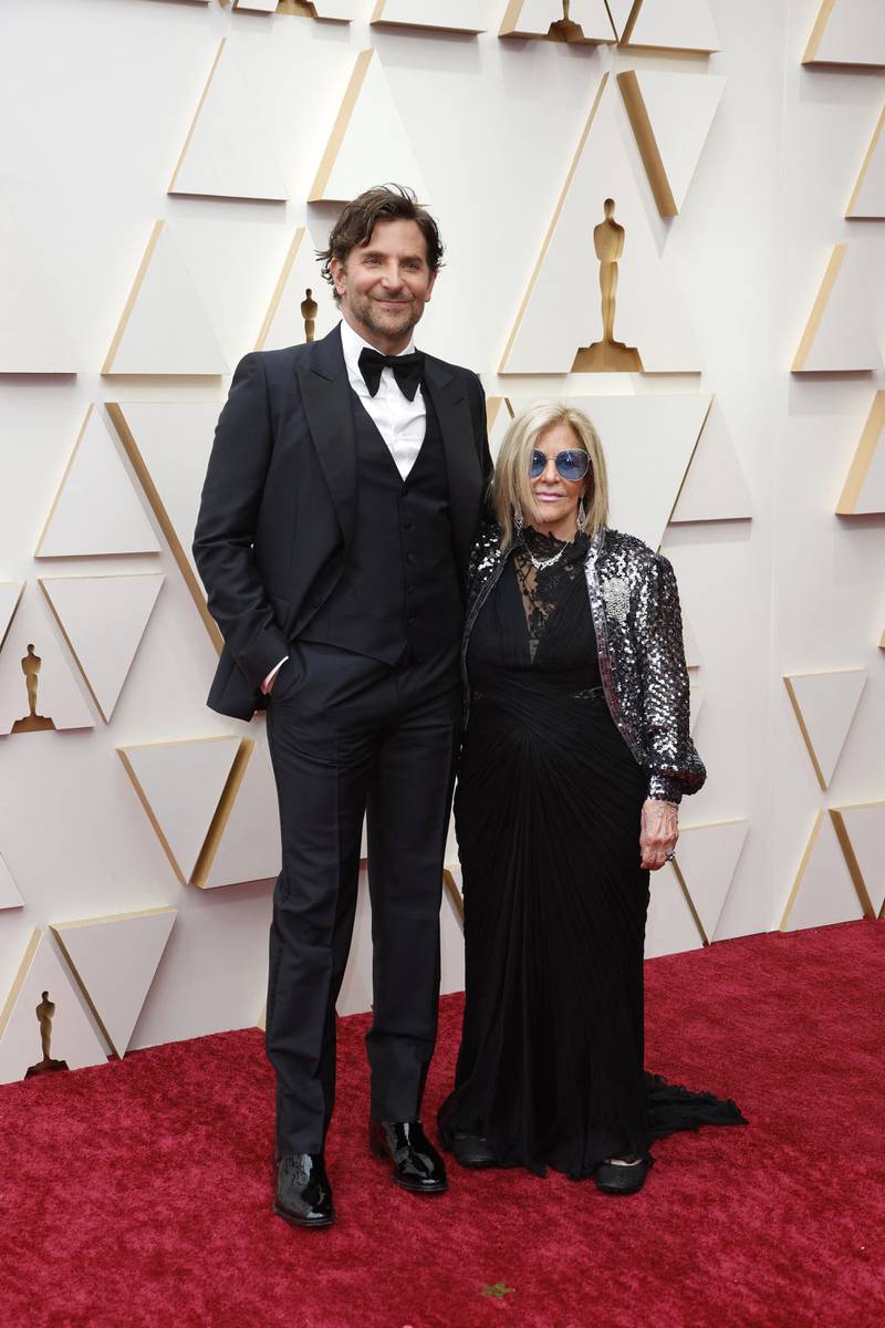 Bradley Cooper, accompanied by his mother Gloria Campano, wears a Gucci tuxedo. Reuters