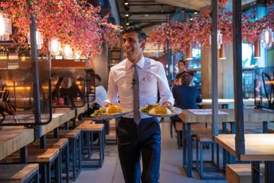 Mr. Sunak, seen here serving food in a branch of Wagamama, has grown his personal brand well. HM Treasury
