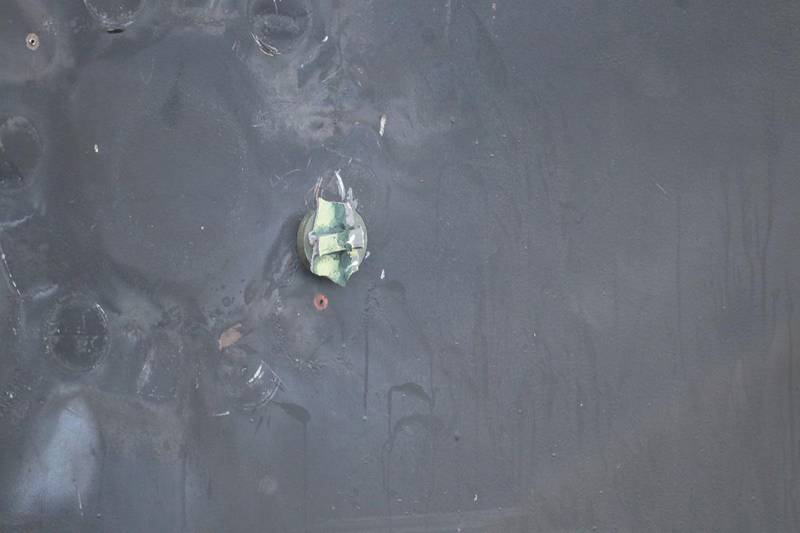 The aluminum and green composite material left behind following the removal of an unexploded limpet mine.
