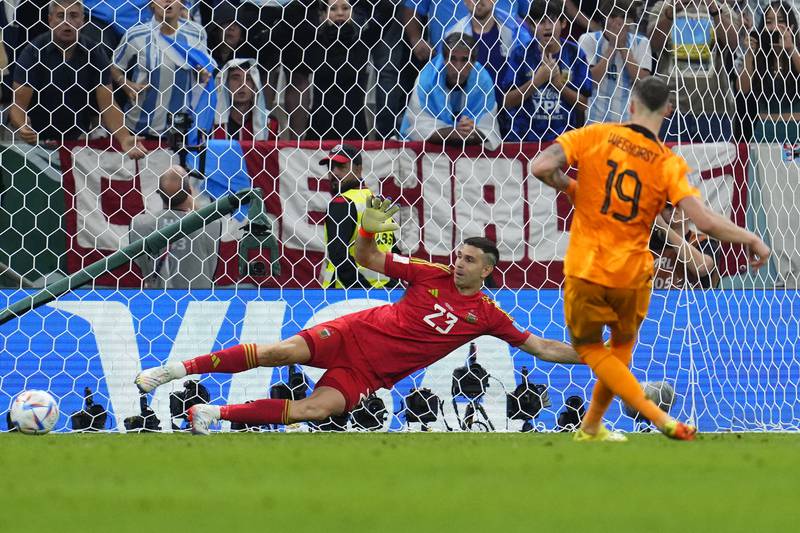 Wout Weghorst of the Netherlands scores past Argentina goalkeeper Emiliano Martinez in the penalty shoot-out. AP