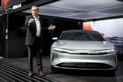 Peter Rawlinson, chief technology officer for Lucid Motors Inc., speaks next to the company's Air alpha prototype vehicle during the 2017 New York International Auto Show (NYIAS) in New York, U.S., on Thursday, April 13, 2017. The New York International Auto Show, North America's first and largest-attended auto show dating back to 1900, showcases an incredible collection of cutting-edge design and extraordinary innovation. Photographer: Mark Kauzlarich/Bloomberg