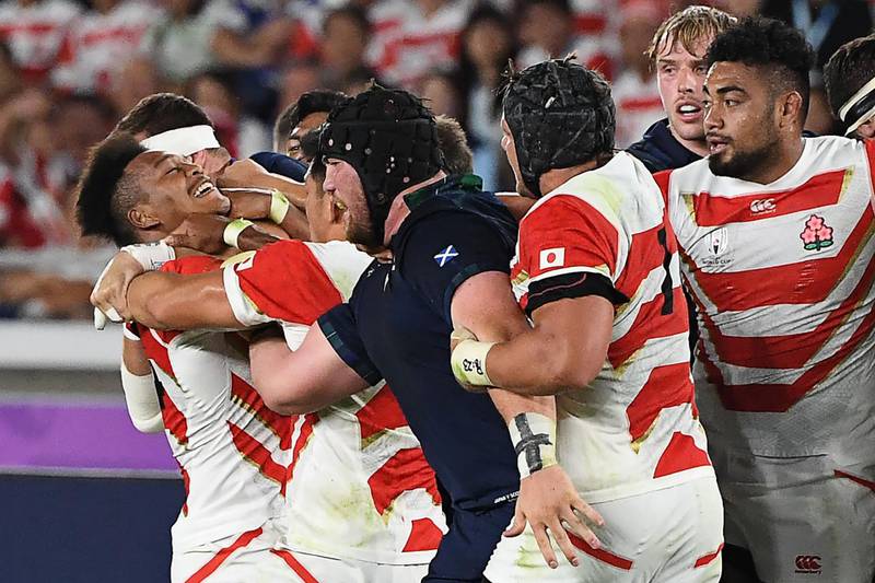 Japan and Scotland players tussle during the Rugby World Cup game. AFP
