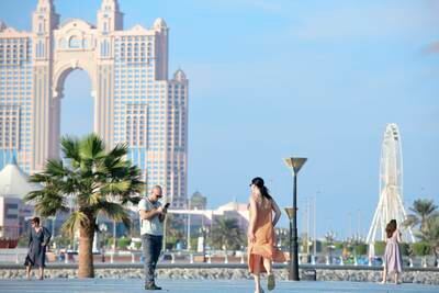Tourists taking photographs during the National Day long weekend at Abu Dhabi Corniche. Khushnum Bhandari / The National