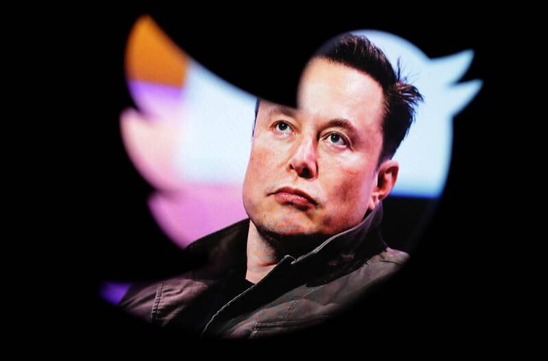 Elon Musk's photo is seen through a Twitter logo. Reuters