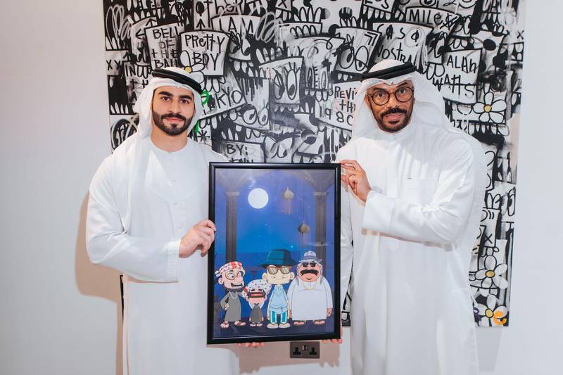 Sheikh Humaid Bin Khalid Al Qasimi (Left) with Haidar Mohammed, the animated show's creator and lead illustrator, after the launch of the Crypto Arabs project. Courtesy Crypto Oasis Company.