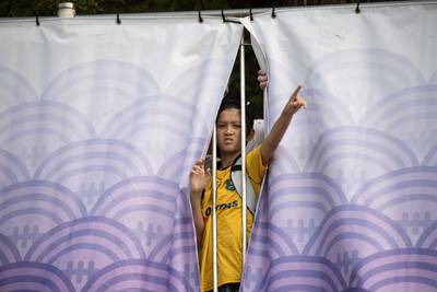 A young Australia fan peers through the fence to watch the team's training session at the Shiroyama stadium in Odawara. AFP