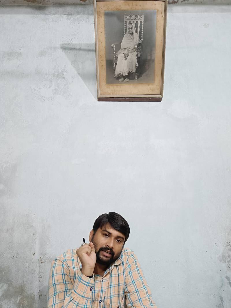 Anurag Shukla at the office of the Kashi Labh Mukti Bhawan. It is a shelter founded by Jaidayal Dalmia, a leading industrialist, in memory of his mother Jadiya Devi, whose pictures hangs on the wall. Tanya Dutta / The National