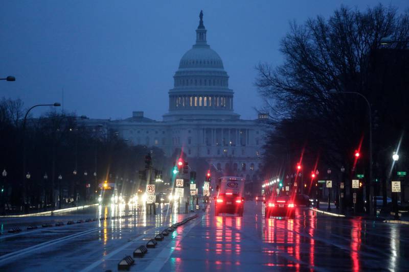 The Capitol is seen early Thursday, Jan. 24, 2019, as rain falls on Pennsylvania Avenue in Washington, with the partial government shutdown in its second month. The Senate will vote on two competing proposals today to end the impasse, but neither seems to have enough votes to advance. (AP Photo/J. Scott Applewhite)