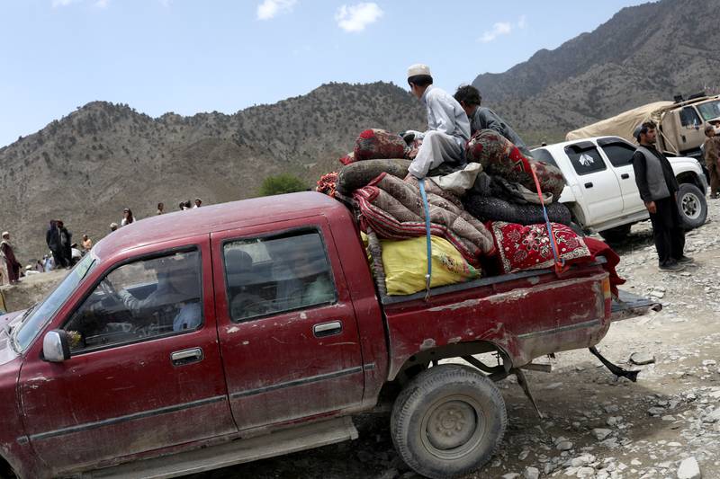 An Afghan family carry their belongings following the earthquake. Reuters