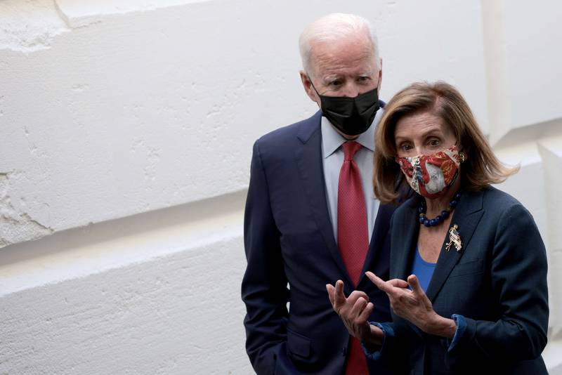 US President Joe Biden and Speaker of the House Nancy Pelosi leave a meeting with members of the House Democratic caucus on October 1, in Washington. Getty Images / AFP