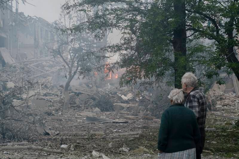 An elderly couple stands near a damaged school in the city of Kramatorsk in eastern Ukraine. EPA 