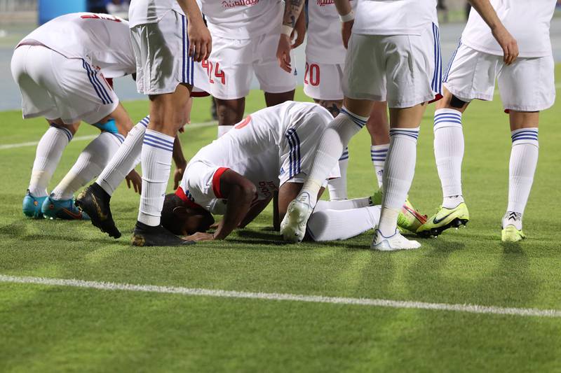 Sharjah forward Ousmane Camara celebrates his opening goal with teammates.