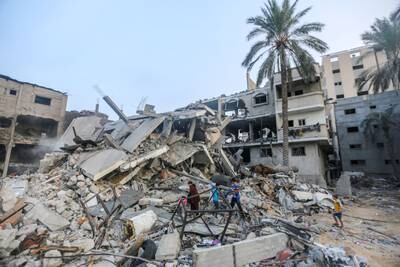 People search through the rubble of buildings destroyed during Israeli air raids in Khan Younis. Getty Images