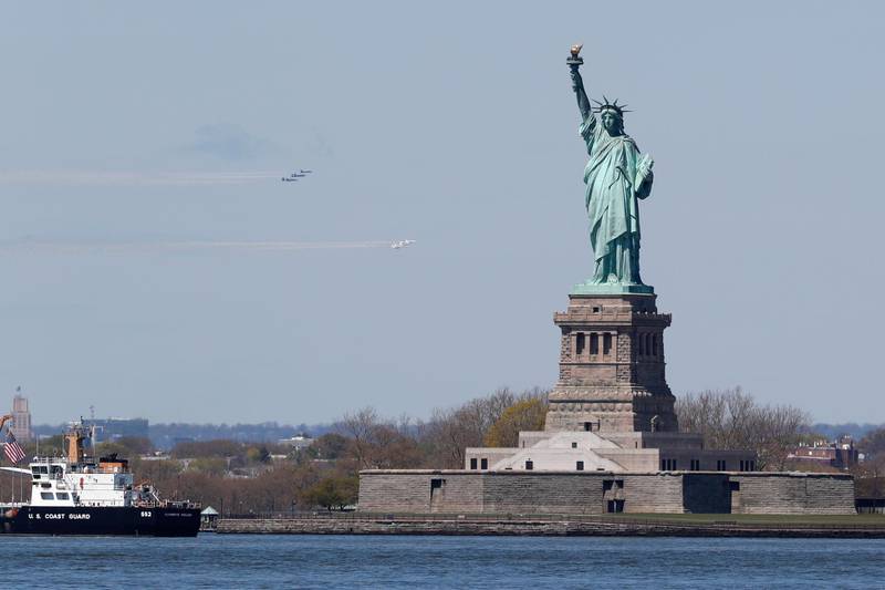 The military's elite flight demonstration squadrons, the Navy's Blue Angels and the Air Force's Thunderbirds, perform "a collaborative salute" to honor those battling the COVID-19 pandemic in a salute to health care and front-line workers during the current coronavirus outbreak, Tuesday, April 28, 2020, in New York. (AP Photo/Kathy Willens)