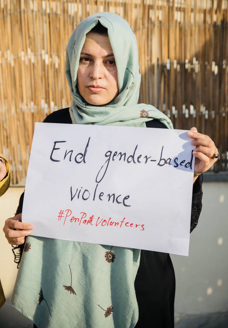A campaigner holds a placard to raise awareness of violence against women in Afghanistan.
