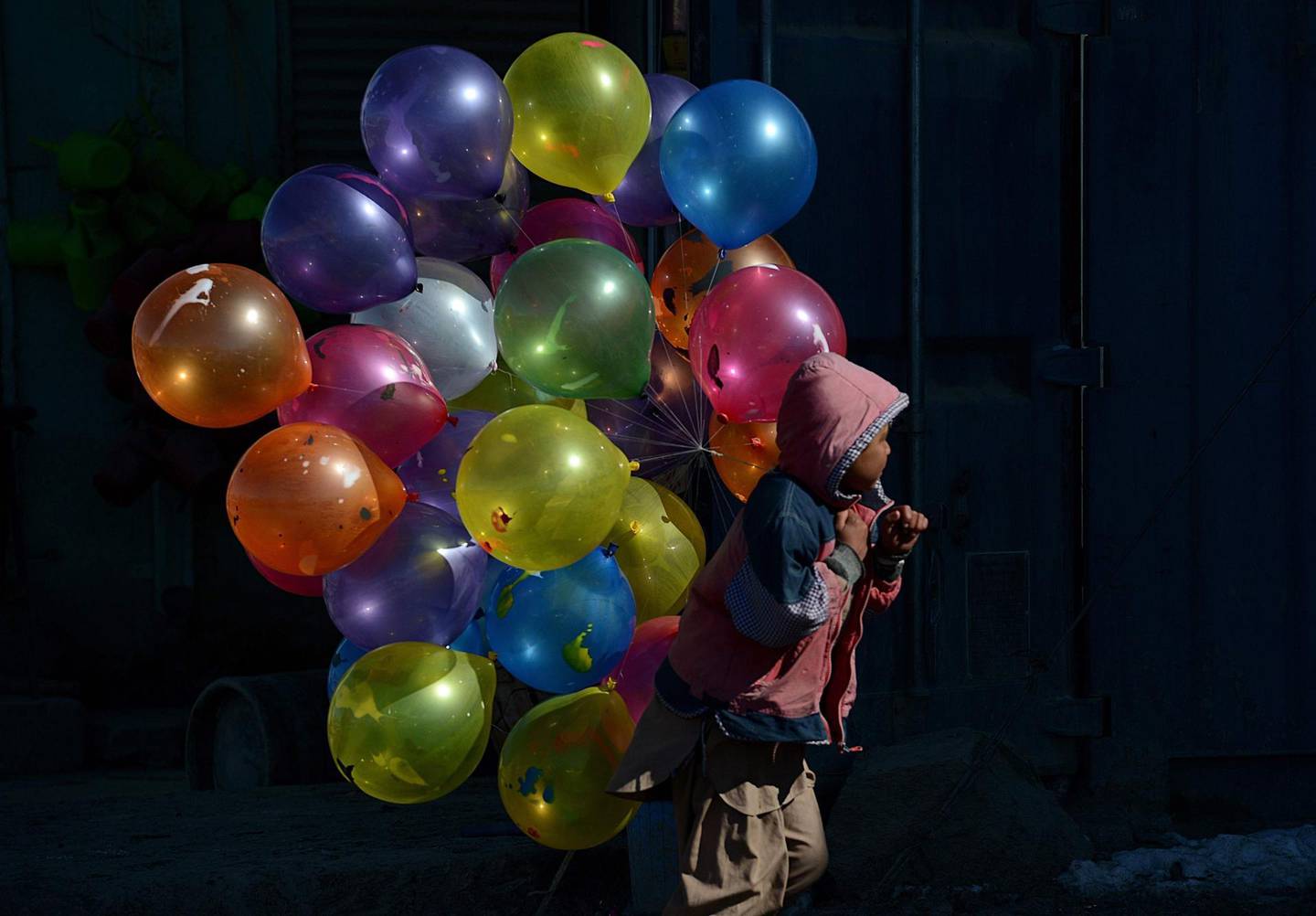 (FILES) In this file photo taken on February 7, 2013 an Afghan boy walks with balloons for sale on a cold winter's day in Kabul.
Agence France-Presse's chief photographer in Kabul, Shah Marai, was killed April 30, AFP has confirmed, in a secondary explosion targeting a group of journalists who had rushed to the scene of a suicide blast in the Afghan capital. Marai joined AFP as a driver in 1996, the year the Taliban seized power, and began taking pictures on the side, covering stories including the US invasion in 2001. In 2002 he became a full-time photo stringer, rising through the ranks to become chief photographer in the bureau. He leaves behind six children, including a newborn daughter.

  / AFP PHOTO / Shah MARAI