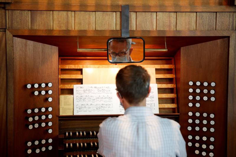 Michael Kleinschmidt plays the Flentrop organ while people are vaccinated against Covid-19 at a clinic held by 6M Geriatrics at Saint Mark's Episcopal Cathedral in the Capitol Hill district of Seattle, Washington, USA. Reuters