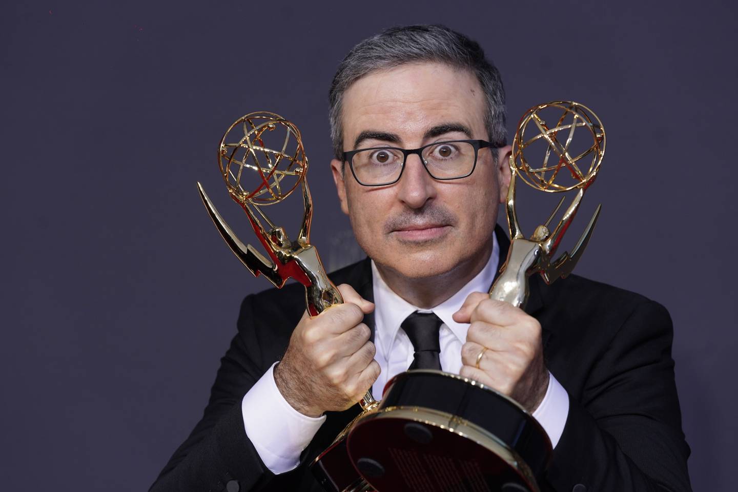 John Oliver poses with the awards for Outstanding Writing for a Variety Series and Outstanding Variety Talk Series for 'Last Week Tonight with John Oliver. AP 