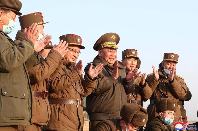 Ri Pyong Chol, the senior leader who is overseeing the test, and other military officials applaud after the launch of a newly developed new-type tactical guided projectile on March 25, 2021 in this photo released March 26, 2021 by North Korea's Korean Central News Agency (KCNA) in Pyongyang, North Korea. KCNA via REUTERS ATTENTION EDITORS - THIS IMAGE WAS PROVIDED BY A THIRD PARTY. REUTERS IS UNABLE TO INDEPENDENTLY VERIFY THIS IMAGE. NO THIRD PARTY SALES. SOUTH KOREA OUT. NO COMMERCIAL OR EDITORIAL SALES IN SOUTH KOREA.