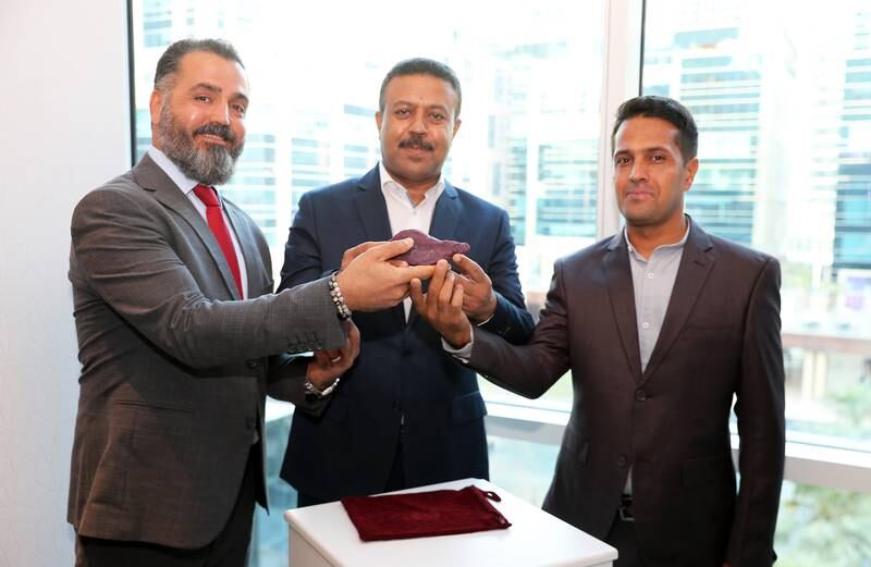 Reza Balali, left, Esmail Borhanzahi and Azad Rokhsati unveil the gem which they say could sell for $10 million. Pawan Singh / The National

