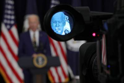 President Joe Biden is seen through a camera viewfinder while speaking to State Department staff. Reuters
