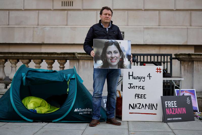 Mr Ratcliffe holds a picture of his wife outside the Foreign Office in London. His hunger strike is aimed at putting pressure on the UK to secure her release. AFP